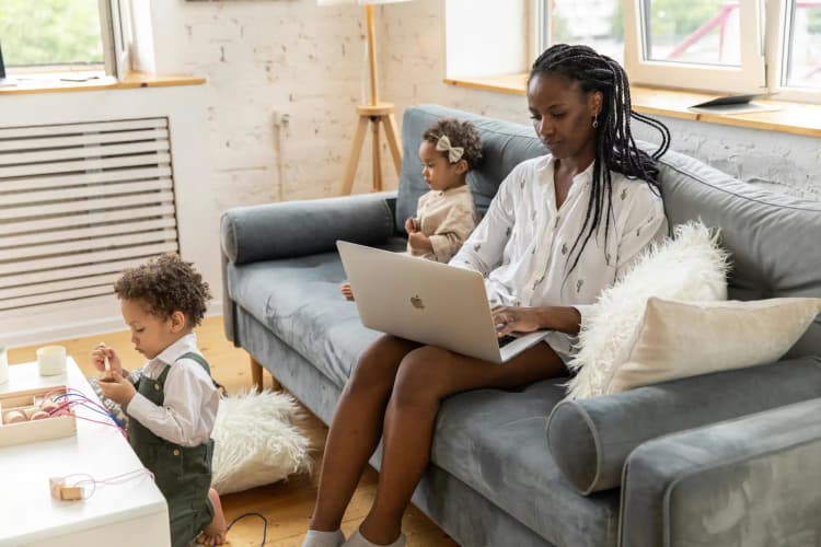 Madre teletrabajando desde casa con sus niños
